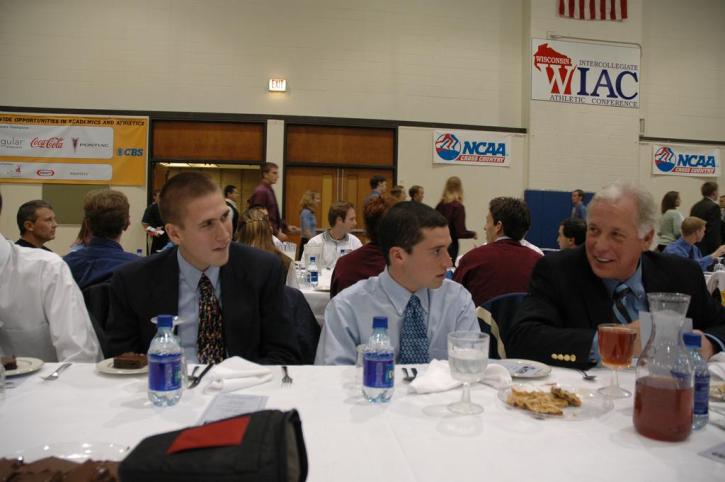 Nate Brigham and Matt Lacey chatting with Connie Putnam at the Dinner Banquet