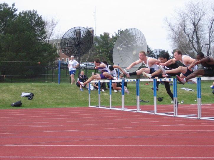 Jamil Ludd and Nate Scott go over a hurdle at NESCAC's
