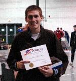 Nate Brigham poses with the second All-American certificate of his career.  He finished 8th in the 5000.