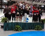 Aaron Kaye and Pat Mahoney pose on the podium with the top 8 teams from the DMR.