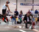 Fred Jones distances himself from the ground in the long jump.