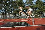 Josh Kennedy and Brian McNamara tackle the water jump in the middle of the steeplechase.
