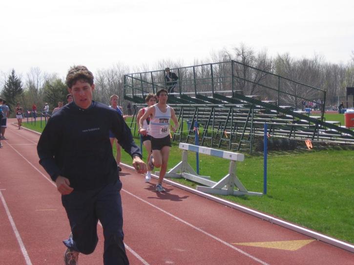 Mike Don runs in the 10K at NESCAC's while Dave McCleary warms up