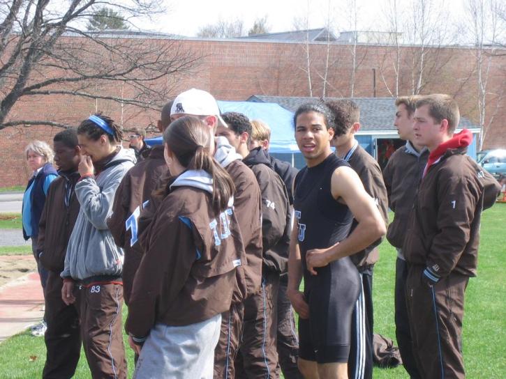 Nate Scott scratches an inch as other team members watch the long jump
