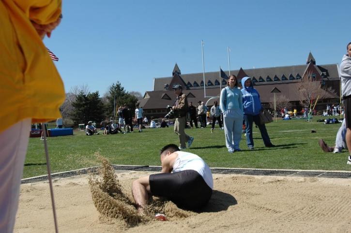 Kenny Kang lands in the long jump