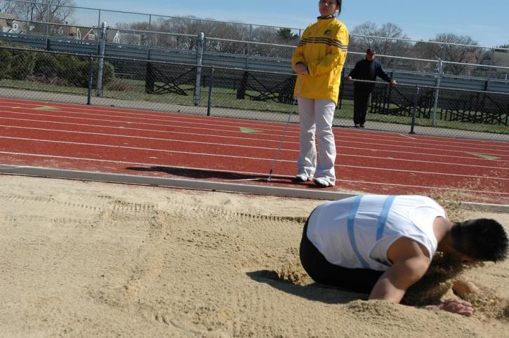 Kenneth Kang lands an attempt in the long jump