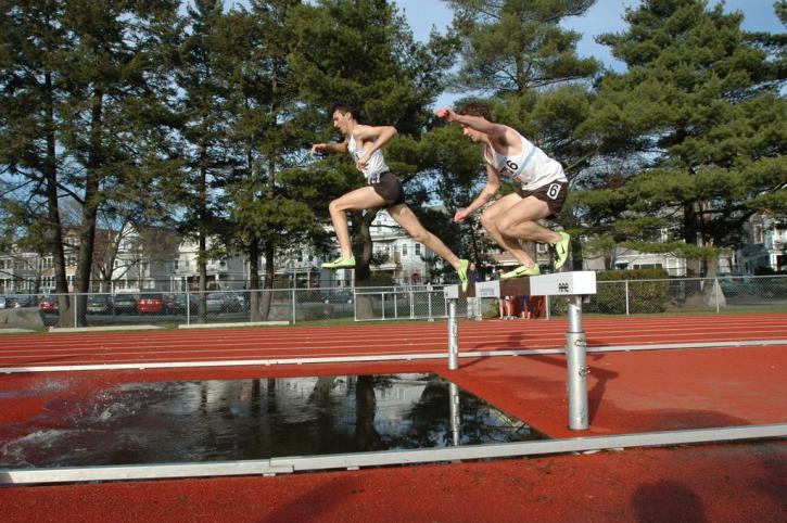 Josh Kennedy and Brian McNamara tackle the water jump in the middle of the steeplechase.